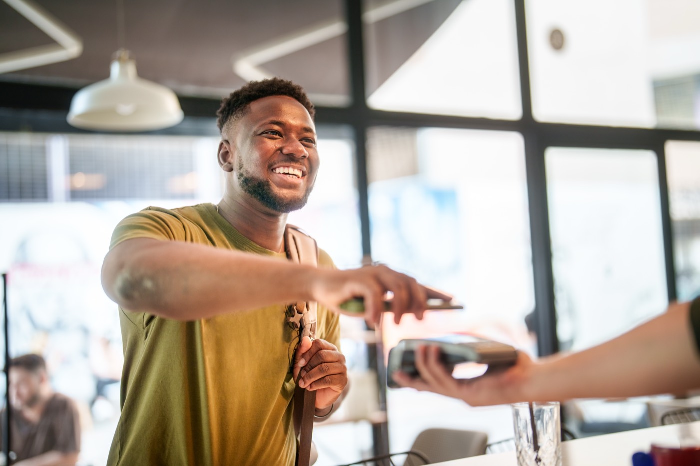 Customer making a contactless payment at a retail counter